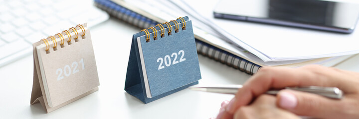 Two calendars for 2021 and 2022 on table closeup