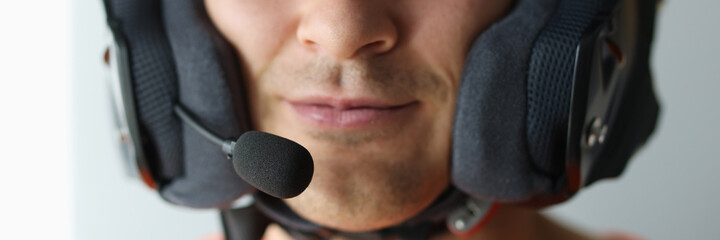 Portrait of man in helmet with microphone for hands-free communication closeup