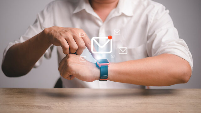Man using smartwatch with e-mail notifier. smartwatch hand device notify computer internet message e-mail concept