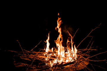 fire and flames. Flames and burning sparks close up, fire patterns. flames from the fire. Night bonfire, logs are on fire, sparks fly. soft focus.shallow focus effect..