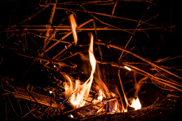 fire and flames. Flames and burning sparks close up, fire patterns. flames from the fire. Night bonfire, logs are on fire, sparks fly. soft focus.shallow focus effect..