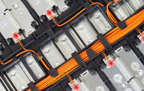 Selective focus of Electric car lithium battery pack and wiring connections internal between cells on background.	