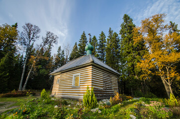 Fototapeta na wymiar Wooden chapel in the name of Alexander Nevsky on a mountain in the autumn forest. Solovetsky Islands 