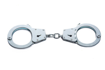 Metal handcuffs on a white isolated background