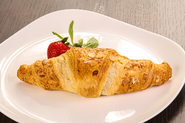Sweet croissant in the plate