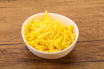 Shredded yellow cheese in the bowl