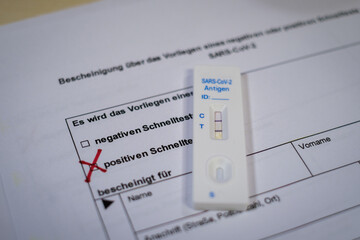 a positive corona covid-19 rapid test is on a test form