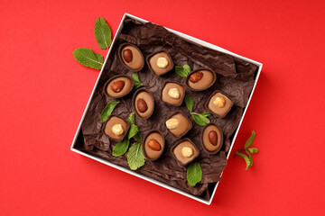 Concept of sweets with chocolate candies on red background