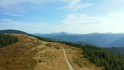 Aerial mountain path scene with stunning rocky pikes background against sky