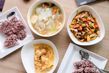 Asian meal with stir fried spicy mushroom , tofu soup and omelet