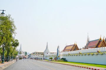 Cityscape, Empty road, Outside white wall of Wat Phra Kaew or Wat Phra Si Rattana Satsadaram, famous temple and destination of tourist in Bangok, Thailand.