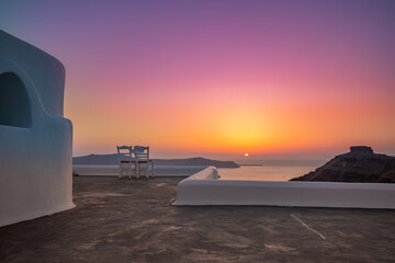 White architecture on Santorini island, Greece. Outdoor restaurant under a fantastic sunset...