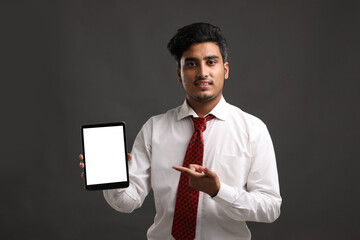 Young indian officer or student showing smartphone screen