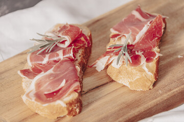 Spanish jamon Serrano, against a stone background.
