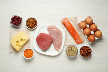 Different fresh products on white wooden table, flat lay. Sources of essential amino acids
