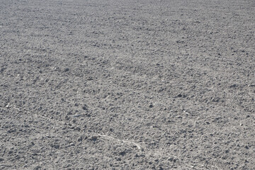 Photo of a plowed field. The texture of black soil after machining. Agriculture. Soil preparation for sowing