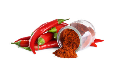 Fresh chili peppers and jar of paprika powder on white background