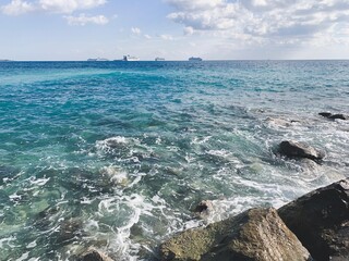 Silhouettes of the ships on the sea horizon