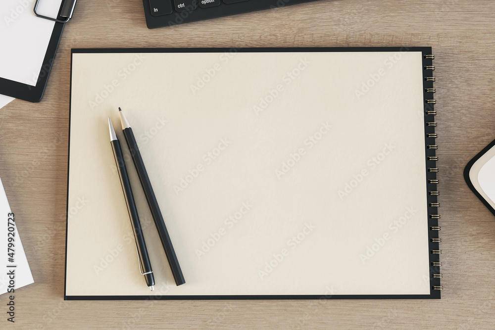 Aufkleber top view of blank spiral notepad on wooden desktop with keyboard and pencils. drawing, workplace, su