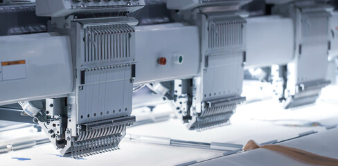 Digital textile industry. Modern computer programmable embroidery machine in garment industry