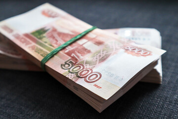 Two wads of money lying on the couch