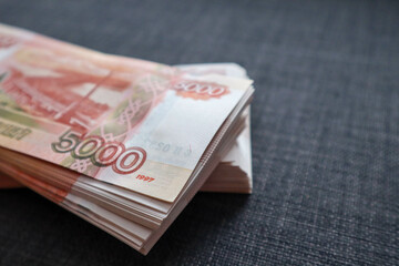 Two wads of money lying on the couch