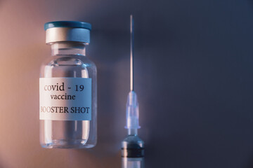 COVID-19 booster vaccine vial. Medicine and health care concept