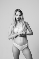 Naklejka premium portrait of exquisite woman in lingerie sitting.
