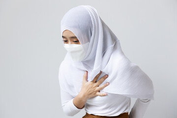 Sick muslim youung woman with face mask having breath shortness or nausea