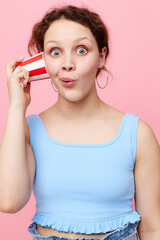 pretty girl drinking from a disposable glass close-up pink background unaltered