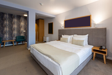 Interior of a luxury hotel double bed bedroom in the evening