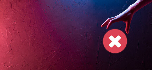 Hand holds icon,cancellation symbol,cancel icon.Cross mark flat red icon.round X mark.cancel button.Wrong.cross mark rejection.Declined.On dark background.Banner.Copy space.Place for text.