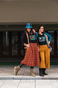 Confident Women in Bold Prints, Striding in Urban Corridor