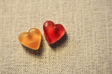 Two marmalade sweet hearts on a light background