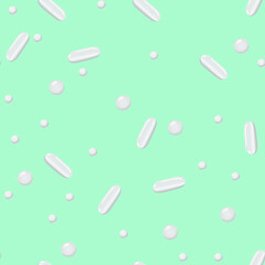 White pills on a colored background. Pattern.