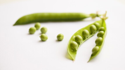 Peas in pod isolated on white background, on table. Fresh pea seeds. Close up.	