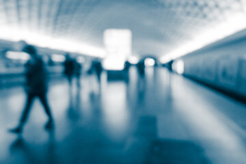 Blurry human silhouette in a subway. Moving human silhouettes in blur.