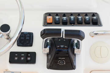 Motor yacht control panel. Steering wheel and gear levers.