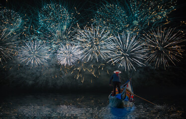 Venetian gondolier punting gondola through green canal - Festive fireworks over the Canal Grande in Venice © muratart