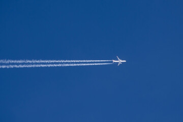 Airplane in the sky aviation airport contrail clouds.