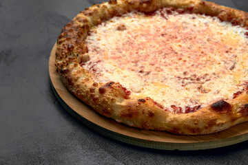 Pizza Margherita on dark stone background, top view. Flyer and poster for Restaurants or pizzerias, template with delicious taste margarita pizza, mozzarella cheese