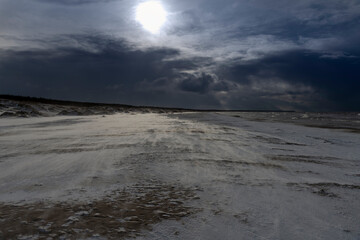 Blizzard on Baltic sea beach in windy day.
