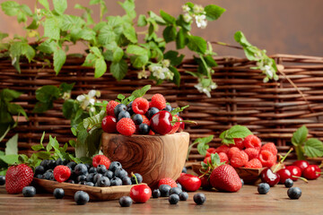 Various fresh berries on a wooden table.