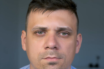 Fototapeta premium Man with white contour on eyebrows before painting in cosmetology clinic, beauty salon. Beautician prepares eyebrows to procedure, closeup face view.