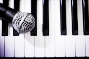 Microphone over piano keys in dim light