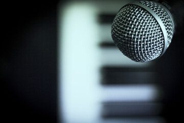 Microphone over piano keys in dim light