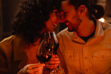 White couple laughing while having romantic dinner at home