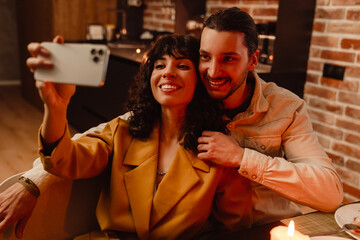 White couple taking selfie on mobile phone during romantic date