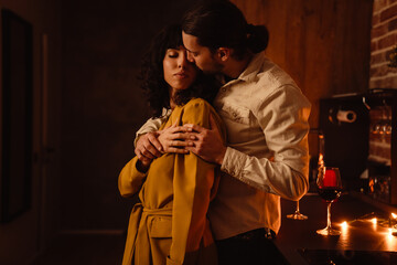 White happy couple hugging during romantic night at home