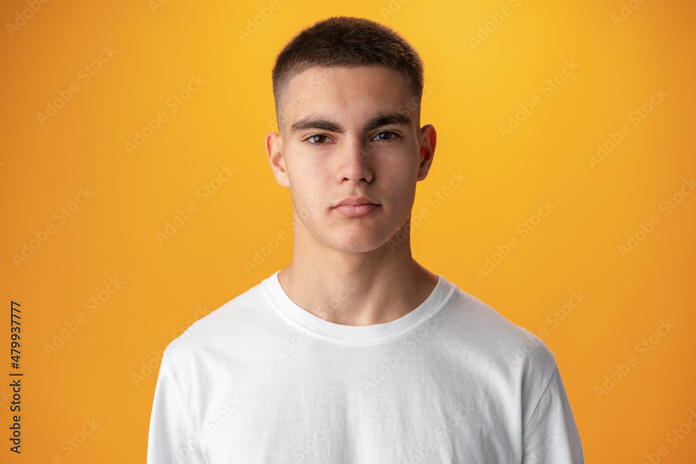 Wall mural portrait of a teen boy smiling against yellow background